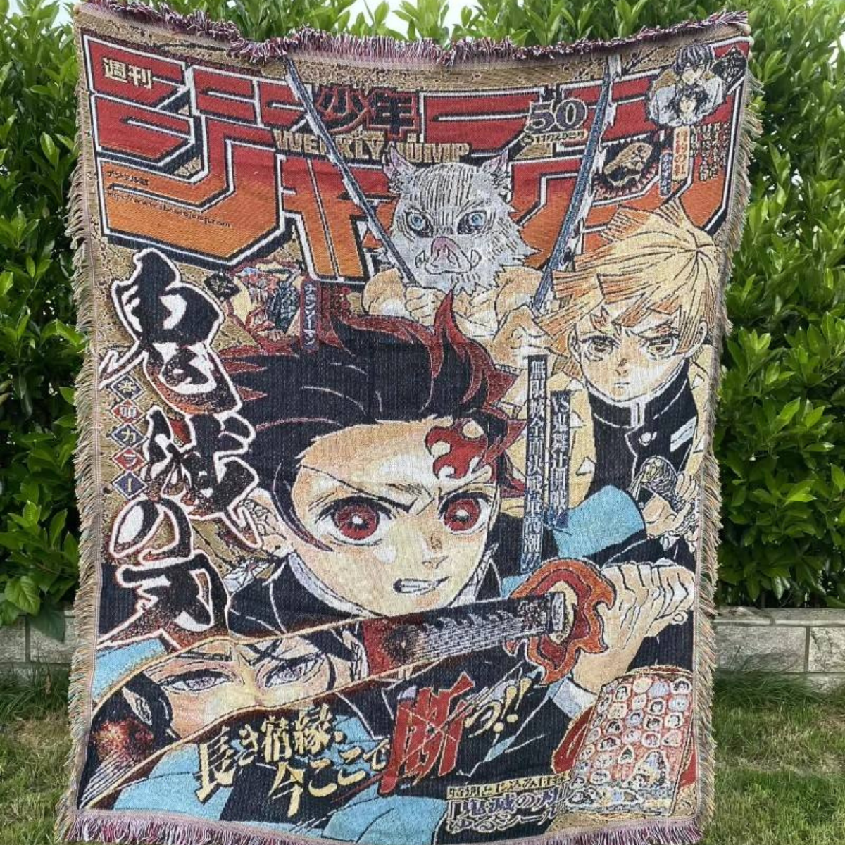 Demon Slayer woven blanket featuring Tanjiro, Nezuko, Zenitsu, and Inosuke in Weekly Shonen Jump cover style, anime throw blanket